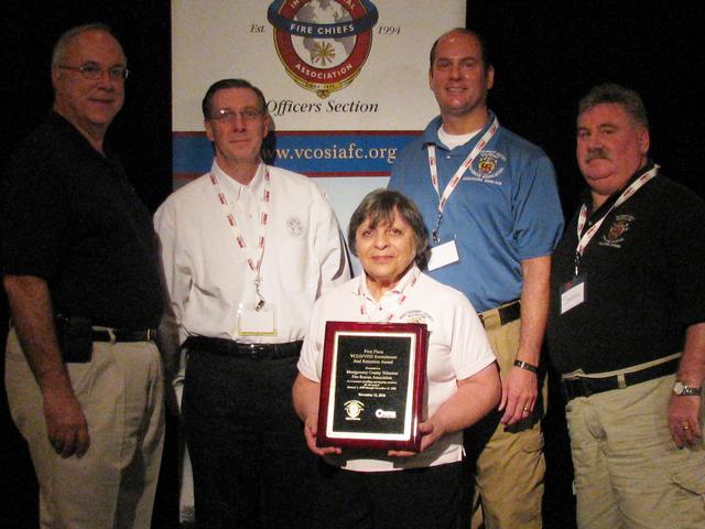 Montgomery County Volunteer Fire & Rescue Association receives the VFIS Recruitment & Retention Award at the IAFC - VCOS Symposium in the Sun. Chief Chornock, President Goodloe, Executive Director Bernard and Director White accept the award from Dr. Bill Jenaway of VFIS.